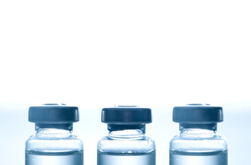 Medical syringe with a needle and a bollte with vaccine.