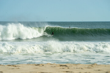 Surfer carving on a green wave.