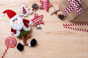 .Christmas composition on wooden background with ribbons and gifts and Santa Claus. Top view. Copy space