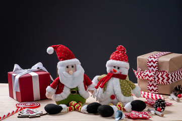 .Christmas composition on wooden background with ribbons and gifts, Santa Claus and snowman. Copy space