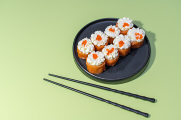 Sushi set on green background with chopsticks