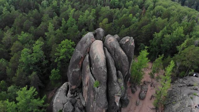  Rocks in the forest. Mountains in the taiga. Krasnoyarsk Pillars National Reserve Park. A very long shot. Aerial view of a drone flying