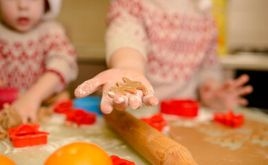 Close up of children's hands cutting cookies out. Homemade baking