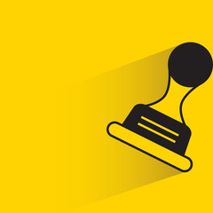 rubber stamp with drop shadow on yellow background