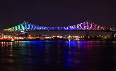 Fototapeta na wymiar Jacques Cartier Bridge illuminated at night in Montreal, Canada