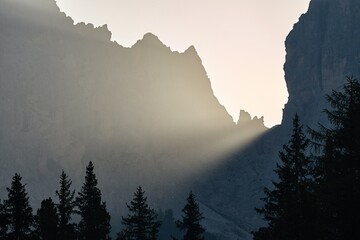 Sunlight beam shining through rock formations on a misty morning
