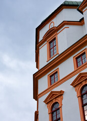 Fototapeta na wymiar Old historic house corner juts into the blue sky