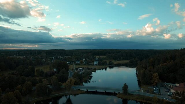 Aerial view of nature lake with bridge after sunset and cloudscape in background.Pomerania,Poland.