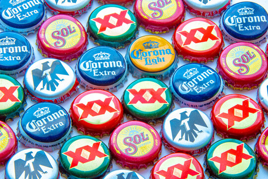 Calgary, Alberta, Canada. Oct 25, 2020. Popular Mexican beer caps on a clear background. Corona Extra, Corona Light, Dos Equis and Tecate.