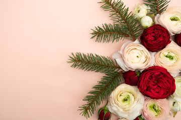 Red roses and ranunculus and fir floral holiday flat lay
