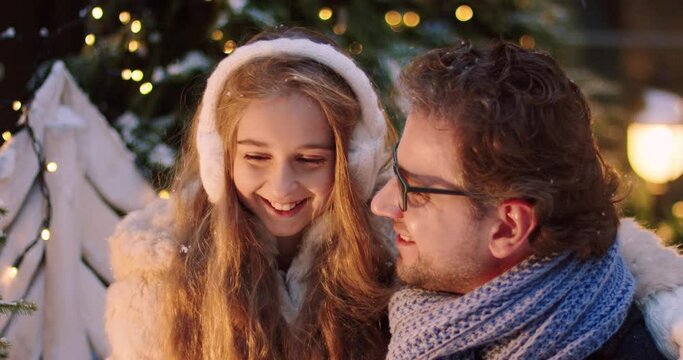 Portrait of happy family: little blonde cute daughter hugs dad. Caring father telling his daughter Christmas stories.