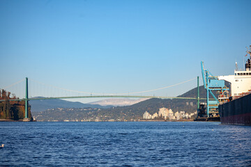 A view of the Lion's Gate Bridge, passing Sea Span, on the way out of Burrard Inlet and passing Coal Harbor in Vancouver, British-Columbia