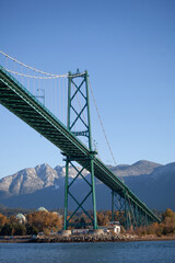 A view of the Lion's Gate Bridge and the North Shore mountains in the background taken from a boat on the water. Looking at North and West Vancouver, British-Columbia