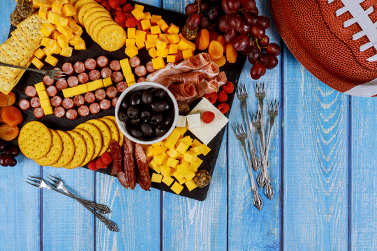 Football Ball Made From Cheese And Sausage For Charcuterie Board. American Football Game Concept.