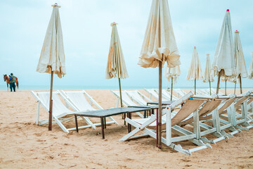 Beach chair and umbrella on the beach.