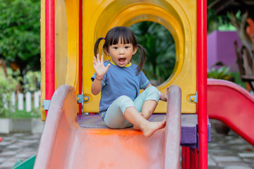 Portrait image of 2-3​ year old of baby. Happy Asian child girl playing with slider bar toy at...