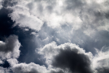Obraz premium Rain clouds background. Clouds become dark gray like a big smoke before rainfall. Thunderstorm is a storm with lightning and thunder. Air pilots know that they must never fly through a thunder cloud.