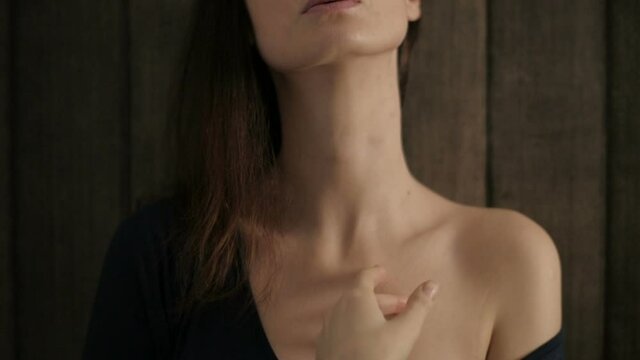 Portrait of  half naked pretty woman touching her neck and lips sensual