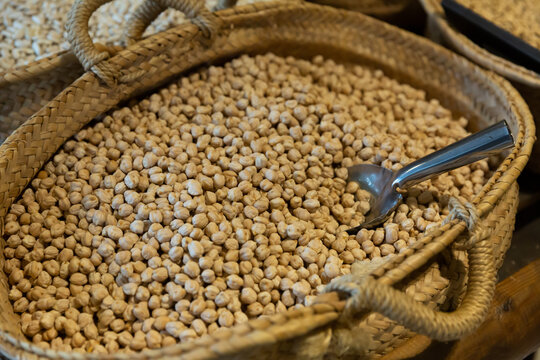 Closeup Of Toasted Chickpeas In Wicker Basket For Sale In Store. Natural Food