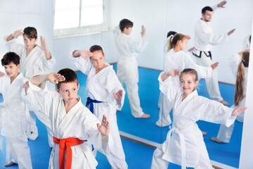 Children trying new martial moves in a practice during karate class