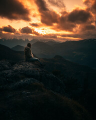 girl on mountain watching sunset in autumn
