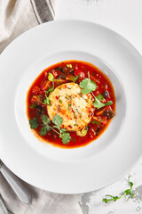 Salmon fish cake with tomato sauce and fresh greens
