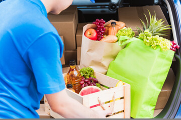 Asian delivery man grocery prepare service giving fresh vegetables food and fruit full in wooden...