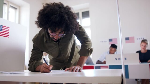 Man voter in polling place, usa elections concept.