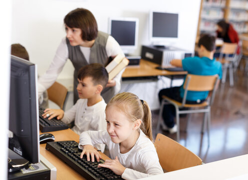 Portrait Of Serious Tween Girl During Lesson In Computer Room Of School Library