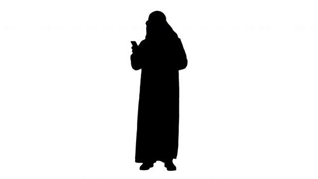 Arab man using his smartphone surfing on the internet or messaging, Alpha Channel