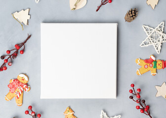 Fototapeta na wymiar Blank canvas frame and Christmas decoration on grey background. Top view. Mockup poster, Christmas design.