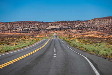 Fototapeta na wymiar Panoramic skyline with empty road. Long Desert Highway California.