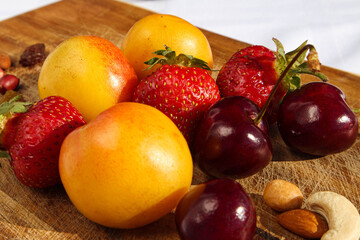 Naklejka na ściany i meble Fruit and berries on a cutting board proper food preparation home cooking foodphoto