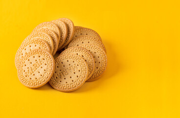 Many Marie biscuits  on bright yellow background. Modern cookies concept. - obrazy, fototapety, plakaty