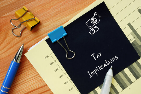 Financial concept about Tax Implications with inscription on the piece of paper.