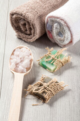 Wooden spoon with white sea salt and handmade soap for bathroom procedures