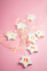 Merry Christmas and Happy Holidays  banner and greeting card. New Year. Wooden stars on a yellow christmas light bokeh background with copy space.Winter holiday theme.Wallpaper.