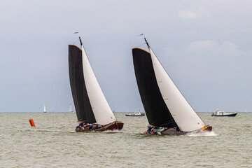 Traditional Frisian wooden sailing ships in a yearly competition on the IJsselmeer, The Netherlands