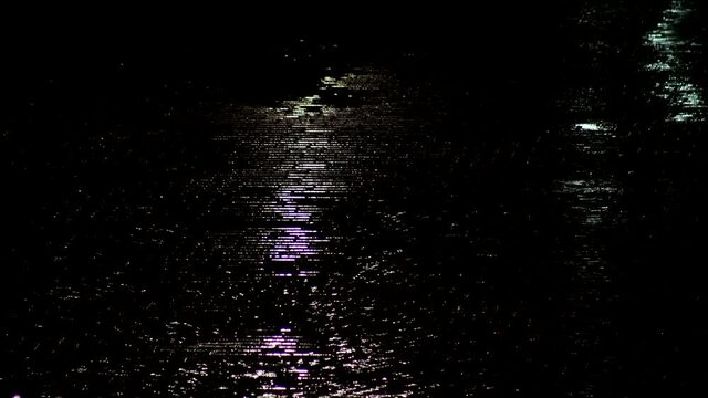Raindrops in a puddle of the night city, background. Heavy rain is falling through the city, outdoors