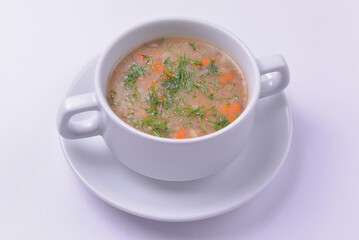 A picture of a bowl of traditional chicken soup served in a bowl over white background.