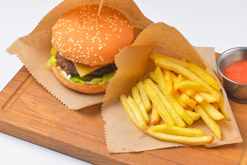 Hamburger with french fries and tomato dip sauce. Fast food, junk food concept.