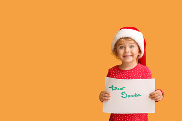 Cute little child with letter to Santa on color background