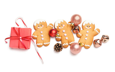 Tasty gingerbread cookies and Christmas decor on white background