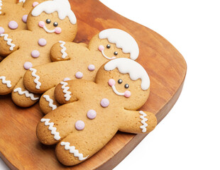 Board with tasty gingerbread cookies on white background