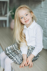 Fototapeta premium Adorable little cute blondie girl smiling at home