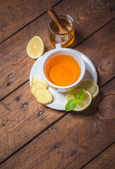 Ginger tea with mint, lemon and honey. Homemade warming tea for colds and flu.