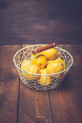 Fresh lemons in a basket on wooden background. Rich source of natural vitamin C.