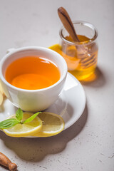 Ginger tea with mint, lemon and honey. Homemade warming tea for colds and flu.