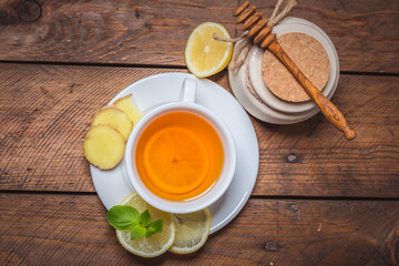 Ginger tea with mint, lemon and honey. Homemade warming tea for colds and flu.