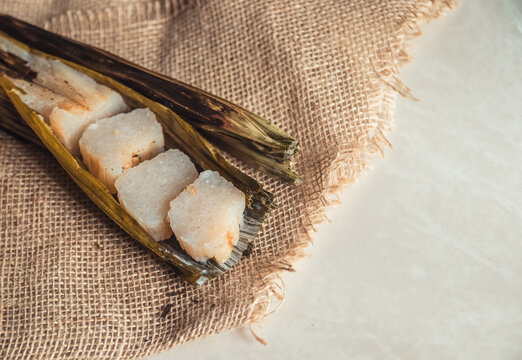 Brazilian traditional dessert. Bolo de tapioca (mane doido, pe de zumbi or pe de moleque nordestino similar to carim&atilde;, cassava cake). Brazilian cake made from tapioca flour, wrapped in banana leaves.